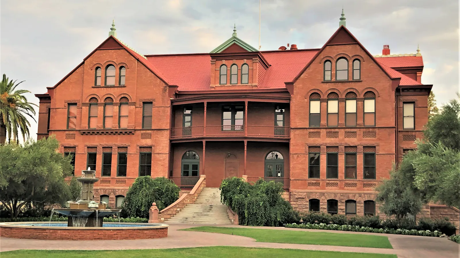 Old Main, the red brick building with its fountain and lawn, on the Tempe campus of Arizona State University
