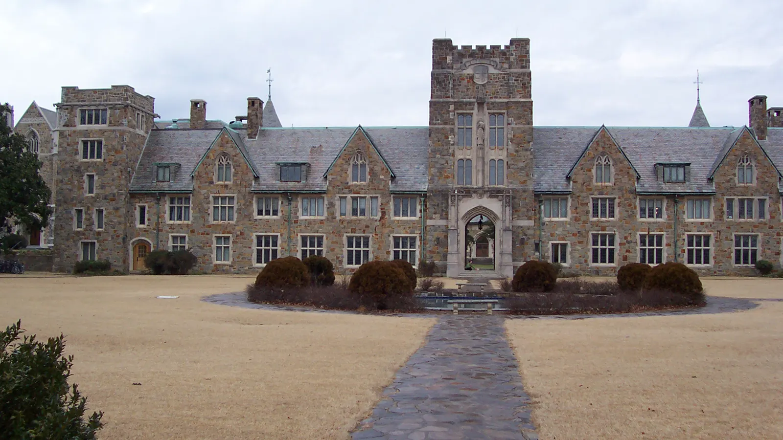 Mary Hall, a stone Gothic building with a tower, behind its lawn and walkway at Berry College in Mount Berry, Georgia