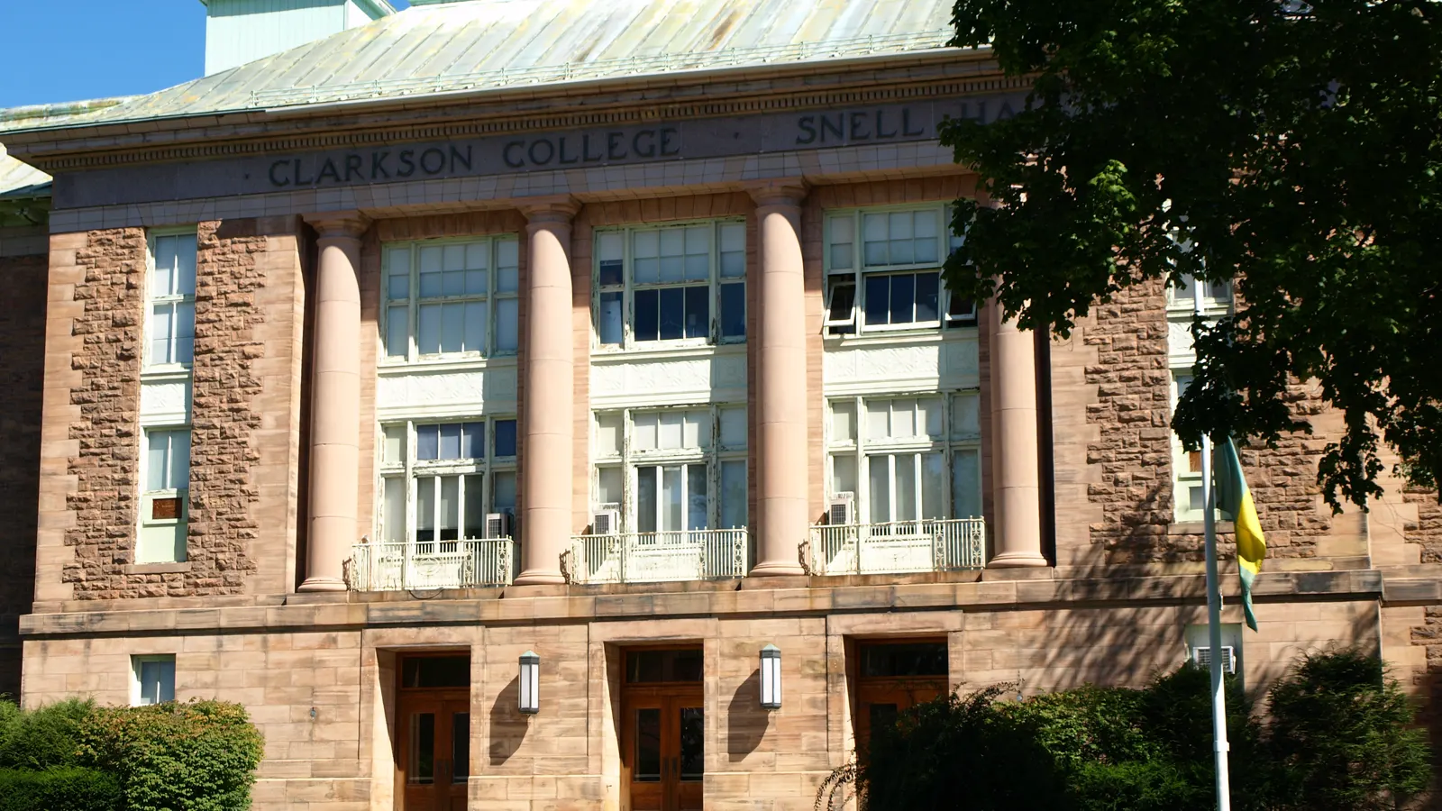 Snell Hall, a columned stone building with Clarkson College carved over the entrance, at Clarkson University in Potsdam, New York