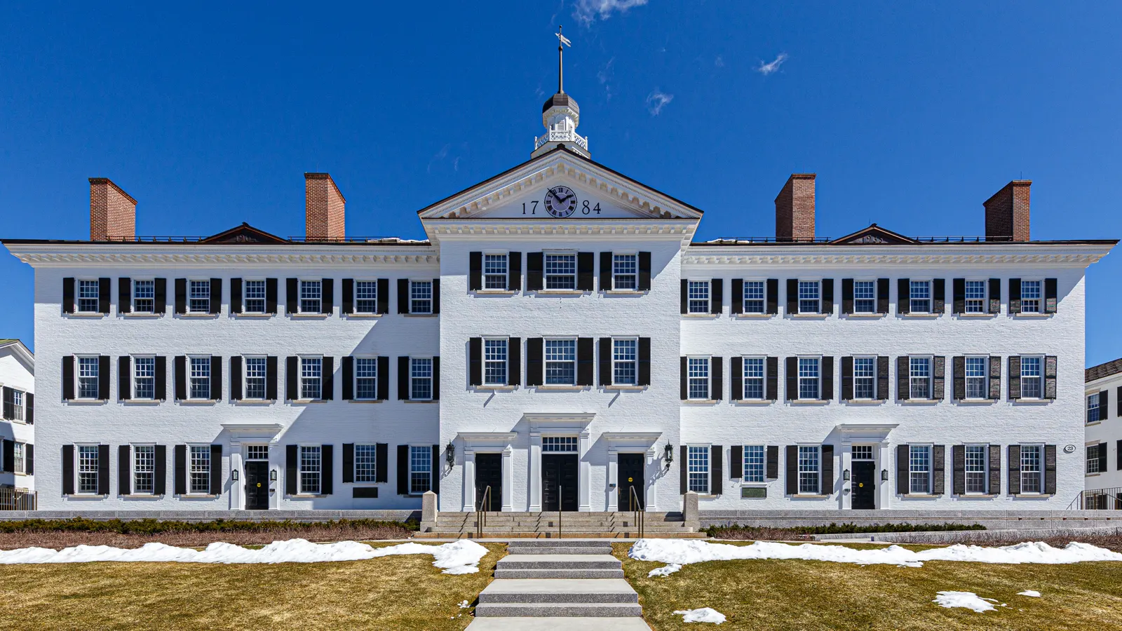 Dartmouth Hall, a white three story building with a clock cupola, at Dartmouth College in Hanover, New Hampshire