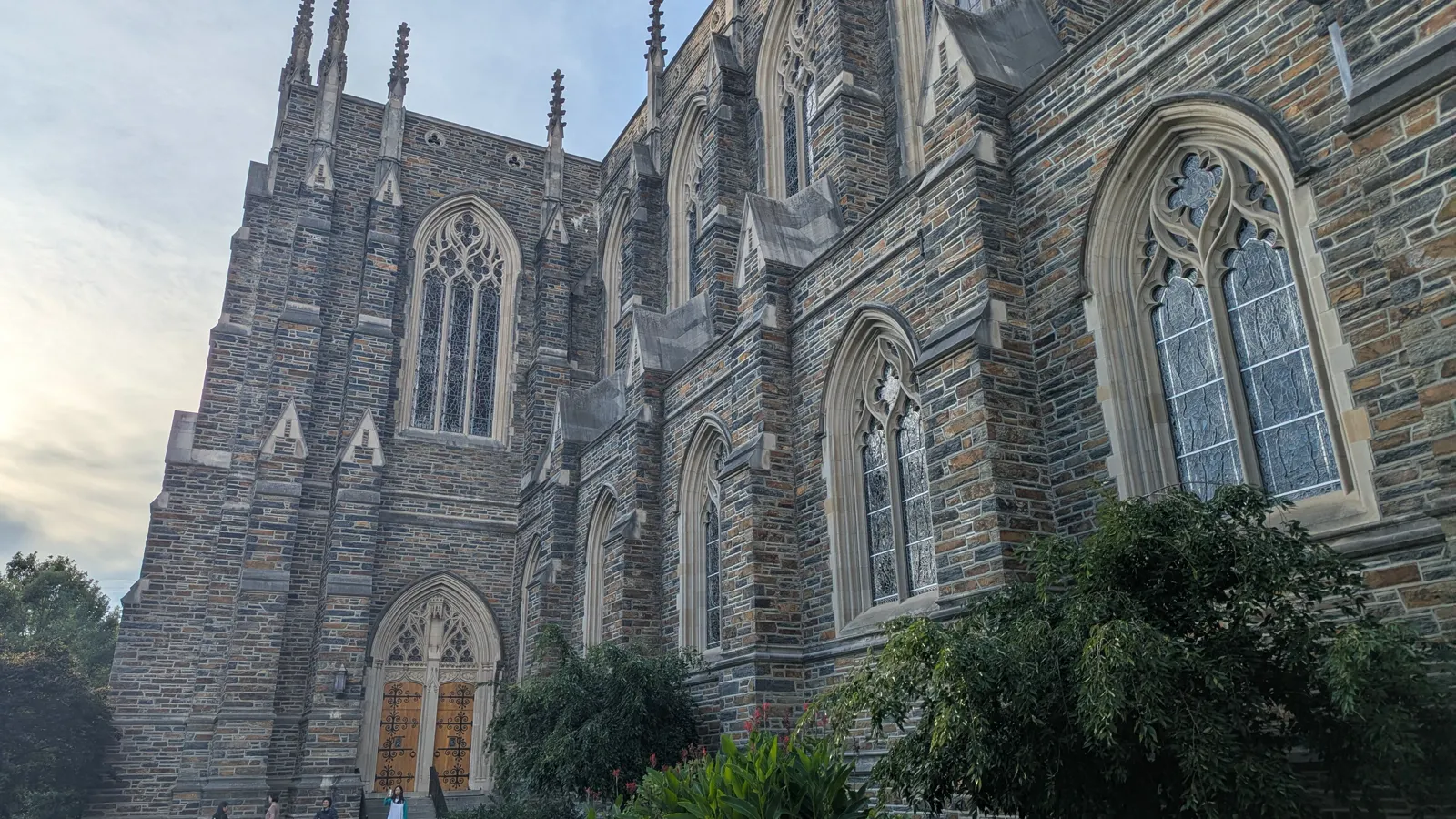 The stone side of Duke University Chapel above a garden walk at Duke University in Durham, North Carolina