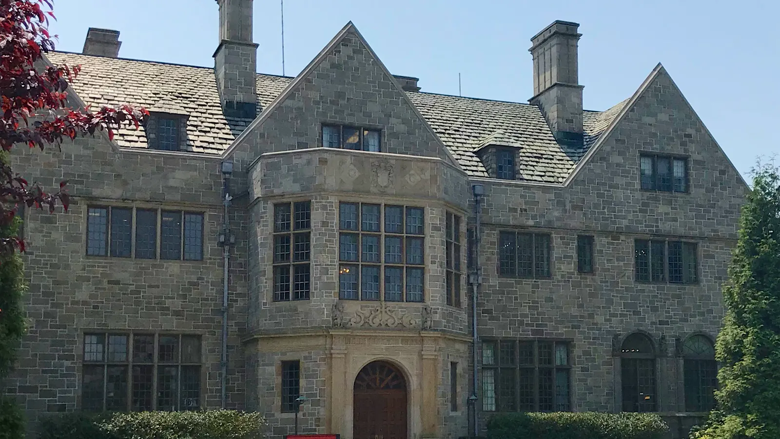 The stone Tudor-style front of Bellarmine Hall at Fairfield University under a clear sky