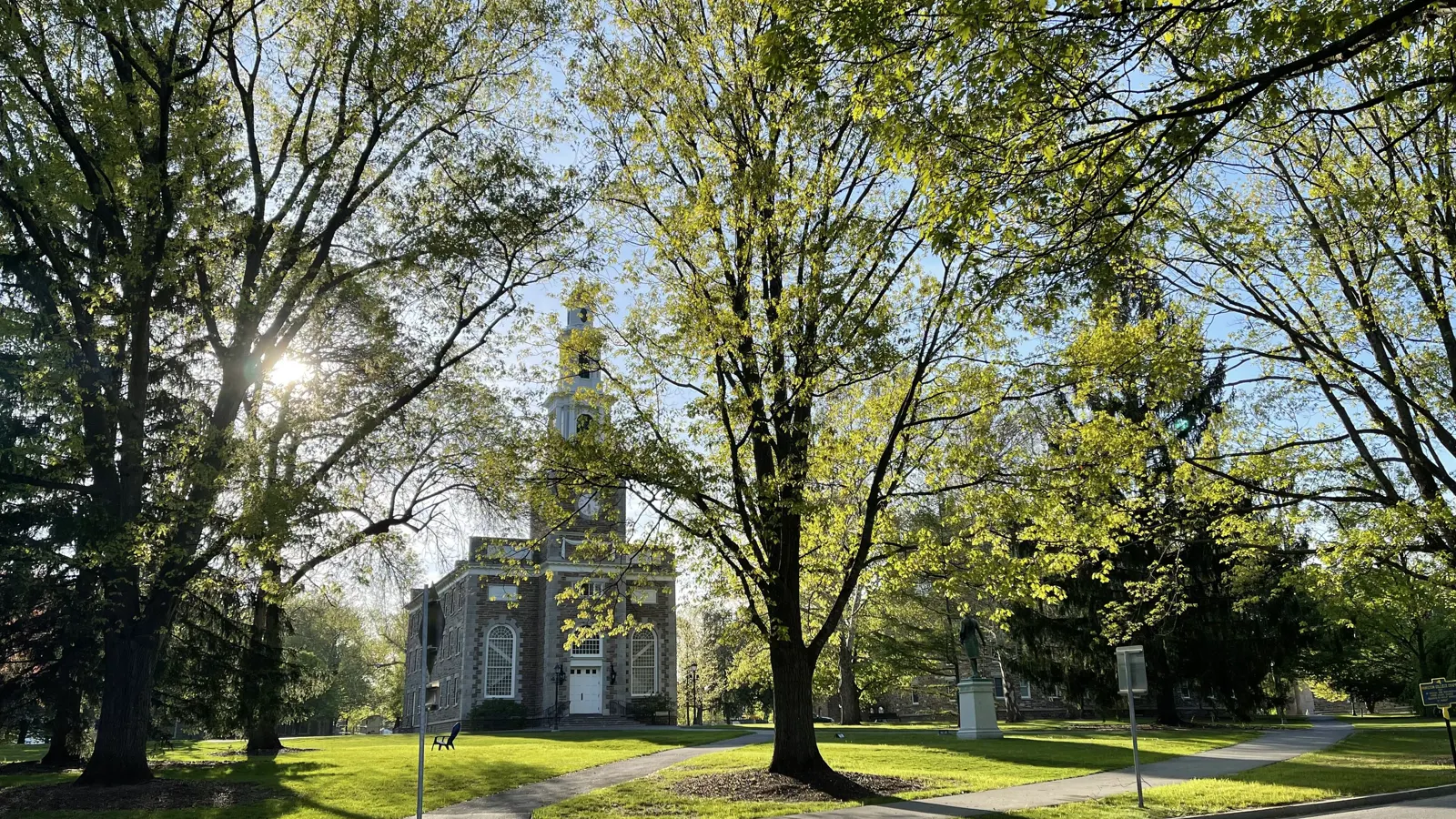 The Hamilton College Chapel among spring trees on the main quad in Clinton, New York