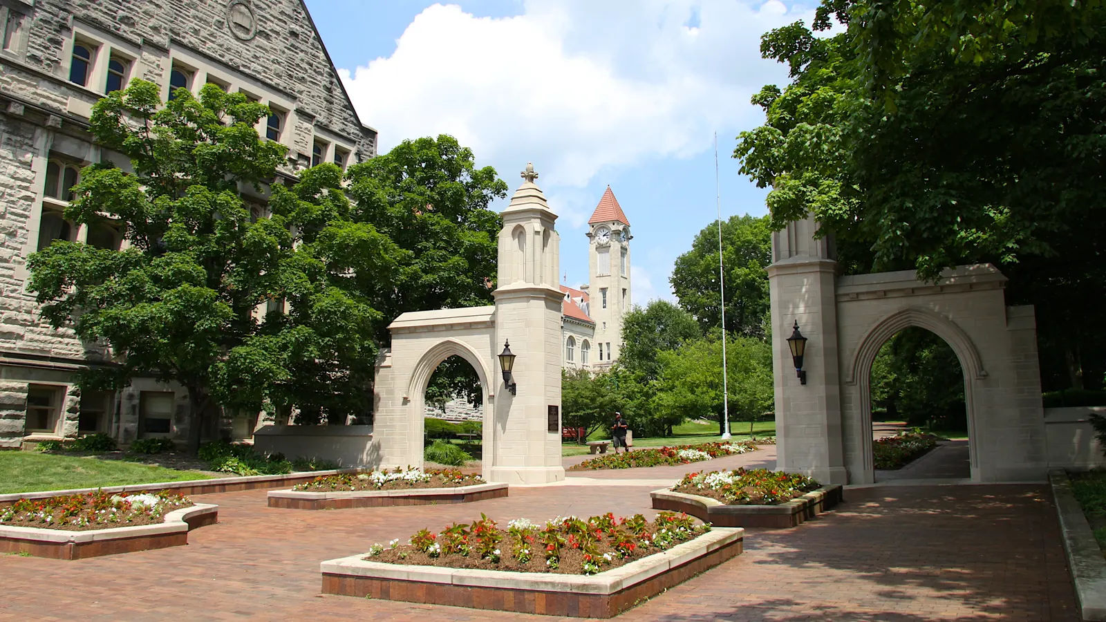 The Sample Gates at the entrance to the Indiana University Bloomington campus, with a clock tower beyond them
