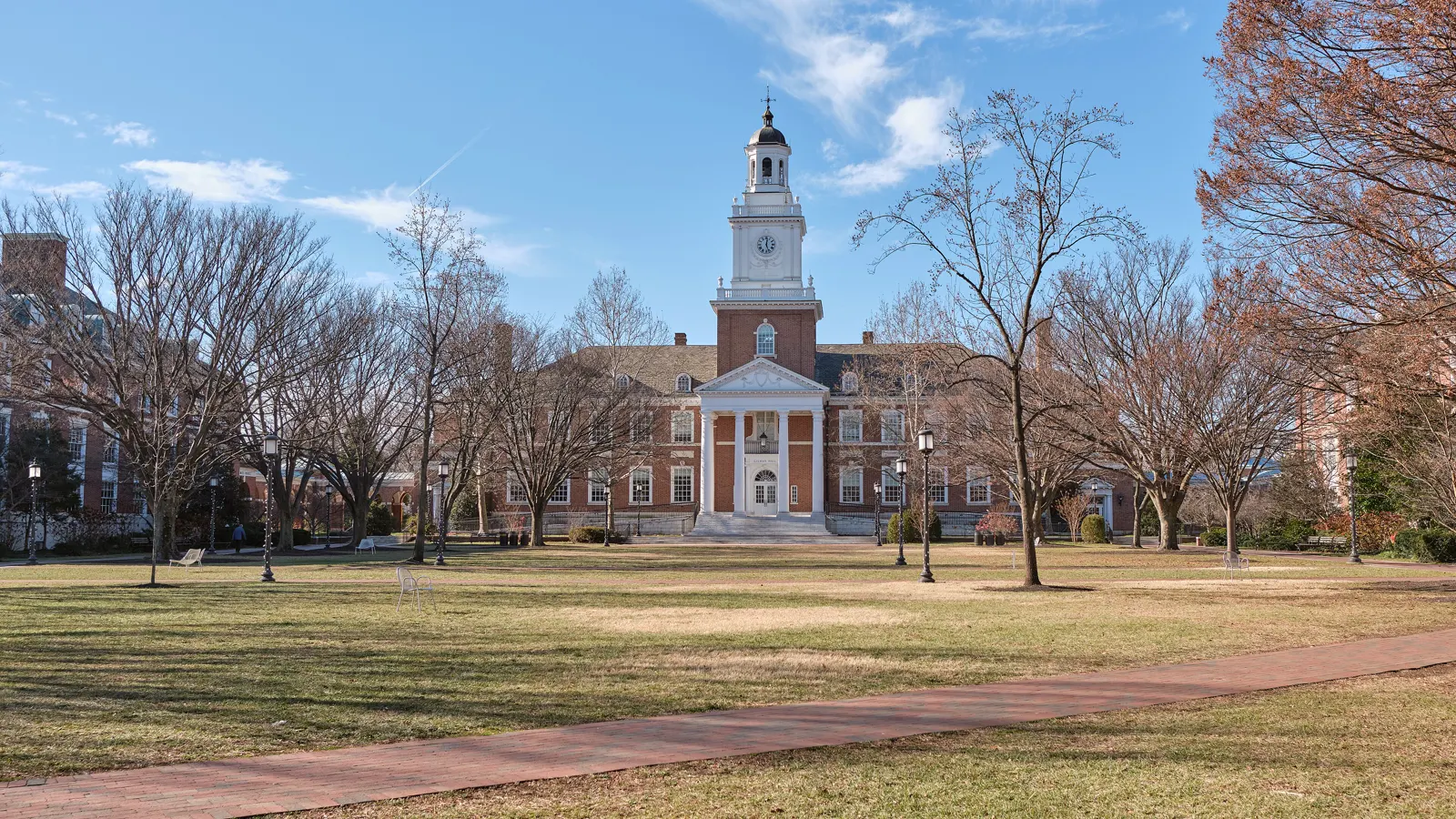 Gilman Hall and its clock tower across the Keyser Quad at Johns Hopkins University in Baltimore, Maryland