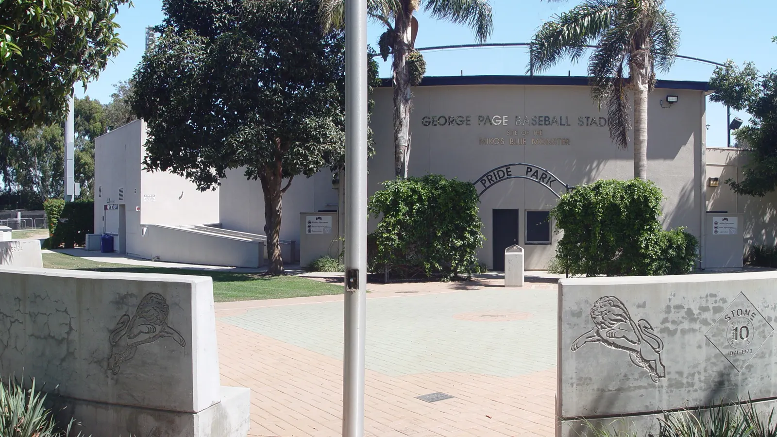 The entrance to George C. Page baseball stadium and Pride Park, framed by palm trees, on the Loyola Marymount University campus in Los Angeles