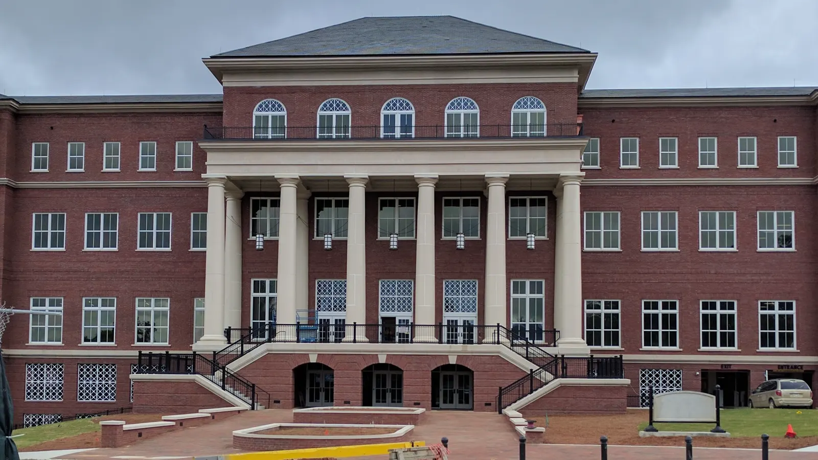 The Old Main Academic Center, a red brick building with a columned entrance, on the Mississippi State University campus in Starkville