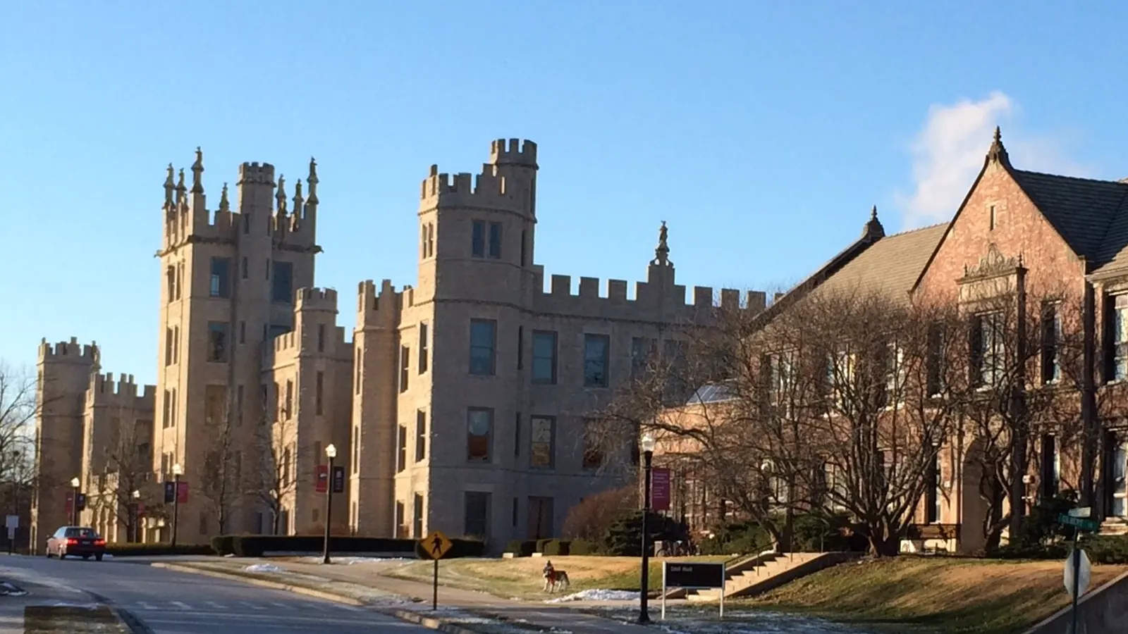 Altgeld Hall, a castle-like stone building with turrets, beside brick Still Hall along College Avenue at Northern Illinois University