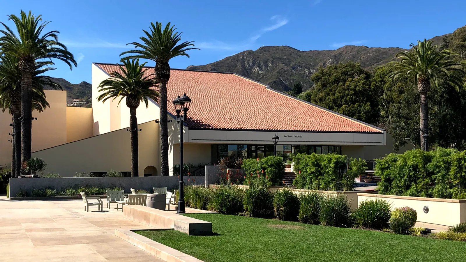 Smothers Theatre among palm trees, with hills behind it, on the Pepperdine University campus in Malibu