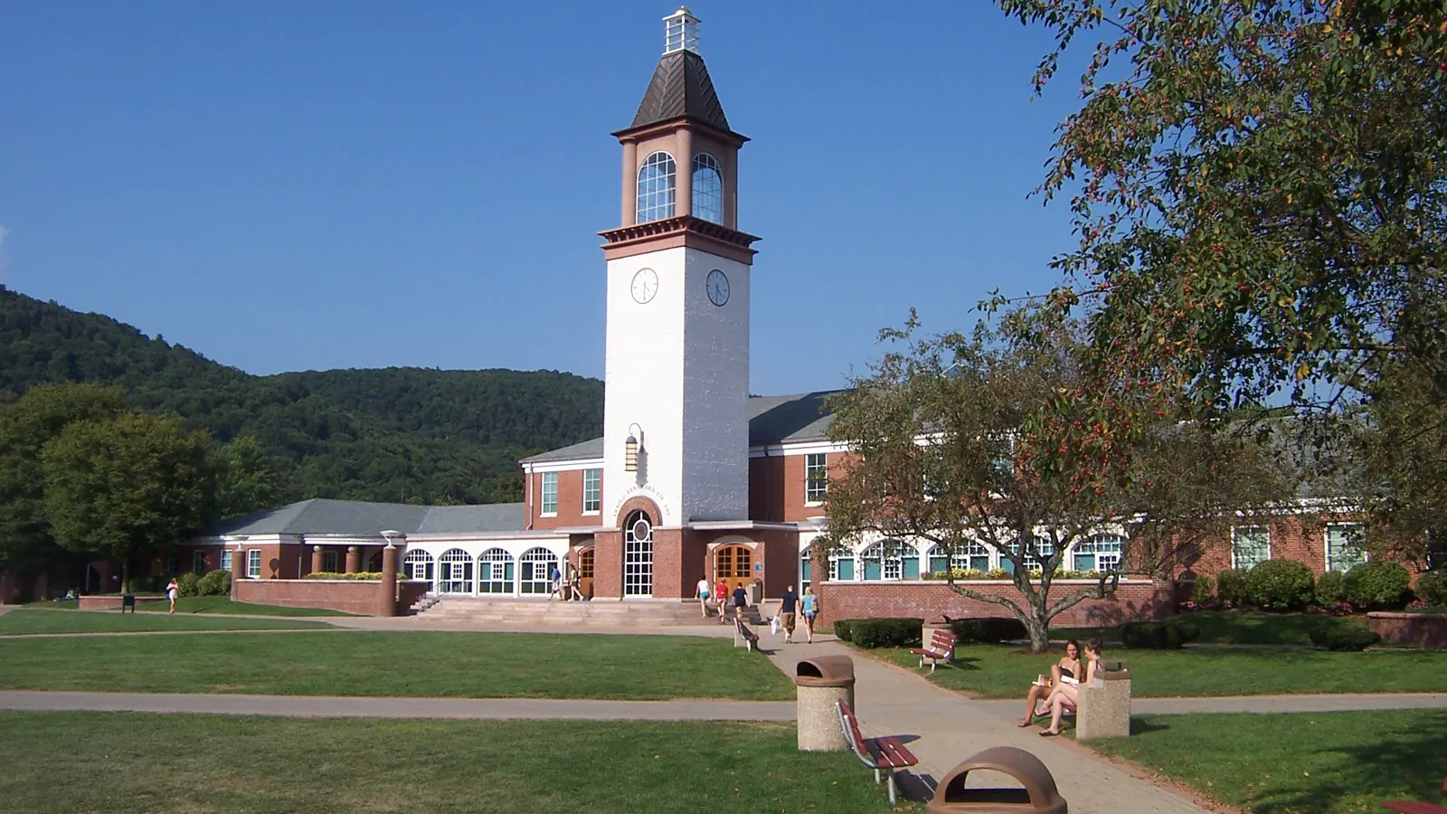 The Arnold Bernhard Library clock tower on the quad at Quinnipiac University in Hamden, Connecticut, with Sleeping Giant behind