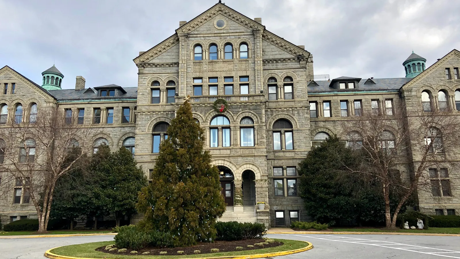 McMahon Hall, a stone building with green copper turrets, at the Catholic University of America in Washington, DC