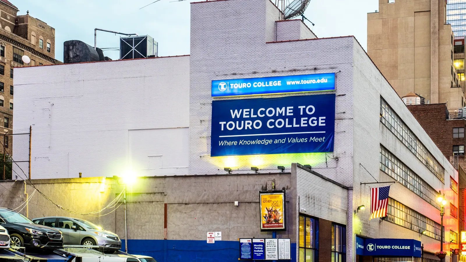 A Touro building with a large Welcome to Touro College sign on its wall in Hell's Kitchen, New York City