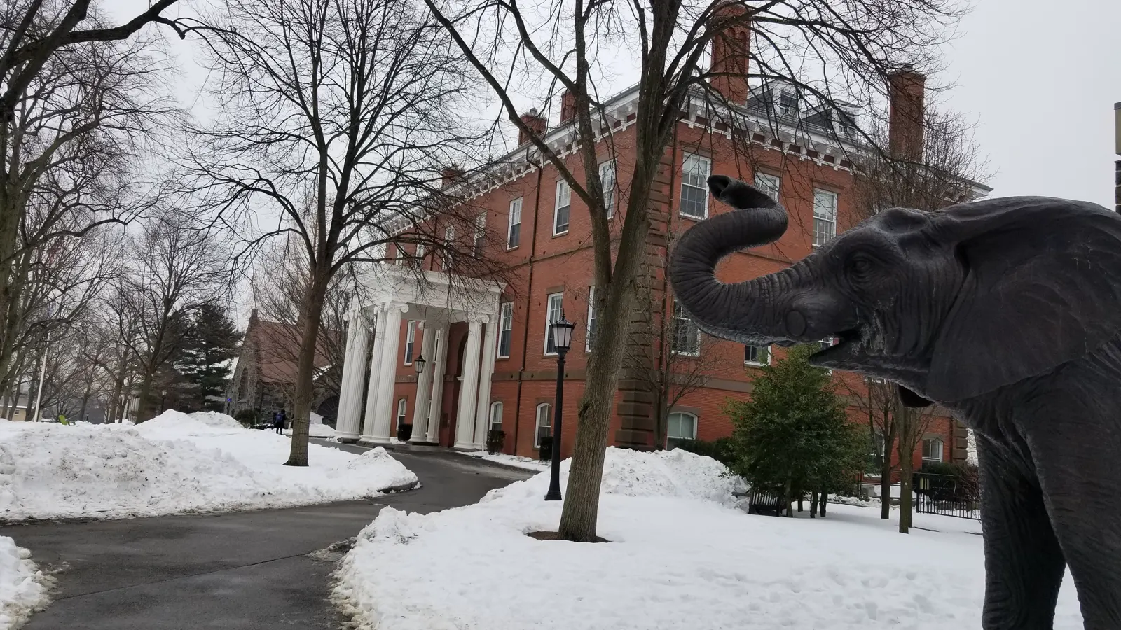 Ballou Hall and the Jumbo statue in winter snow on the Medford campus of Tufts University in Massachusetts