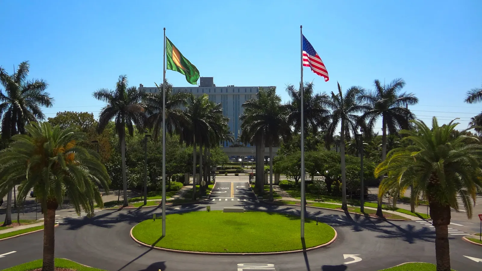 Palm trees and flagpoles at the main entrance to the University of Miami campus in Coral Gables, Florida