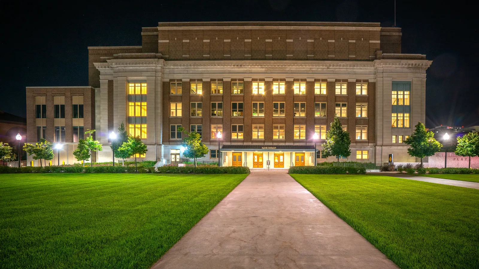 Northrop Memorial Auditorium lit at night on the University of Minnesota campus in Minneapolis