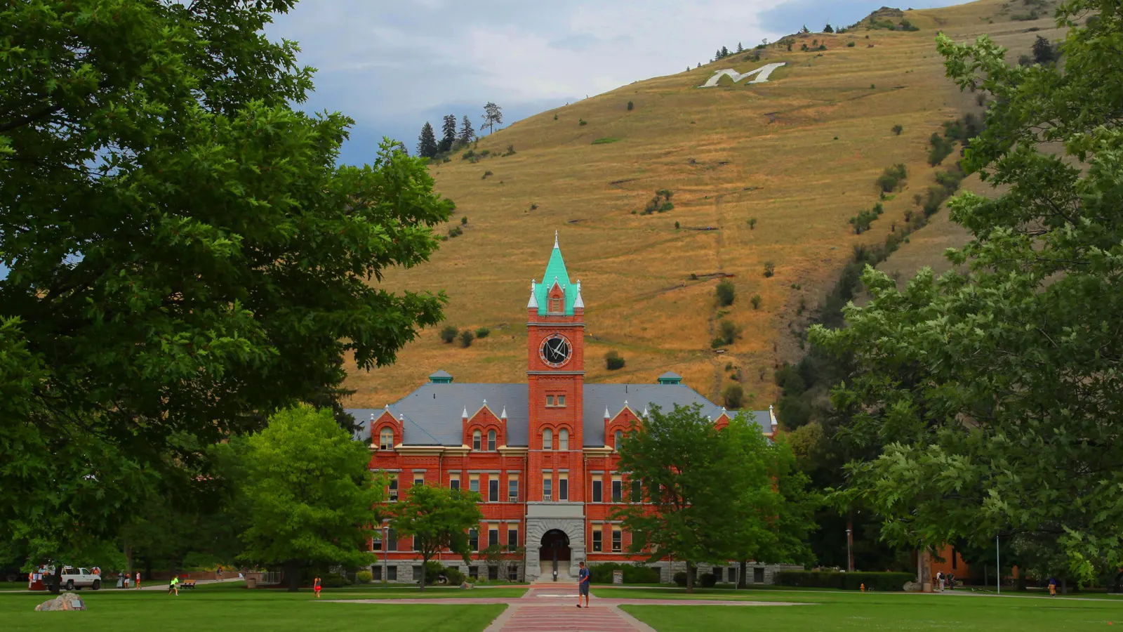 University Hall and its clock tower at the end of the Oval walkway, with Mount Sentinel behind, at the University of Montana in Missoula