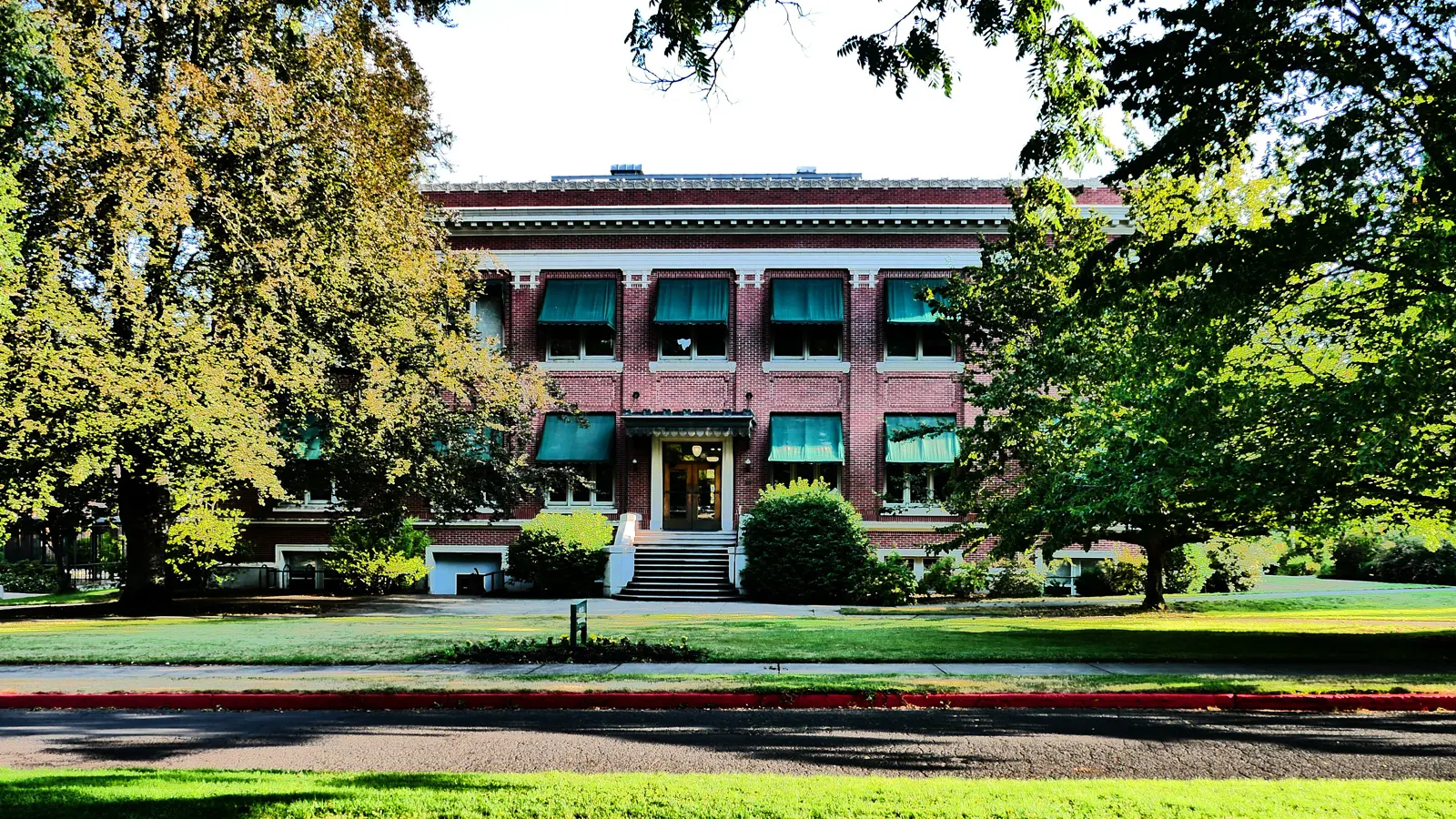 Johnson Hall framed by trees on the University of Oregon campus in Eugene, Oregon