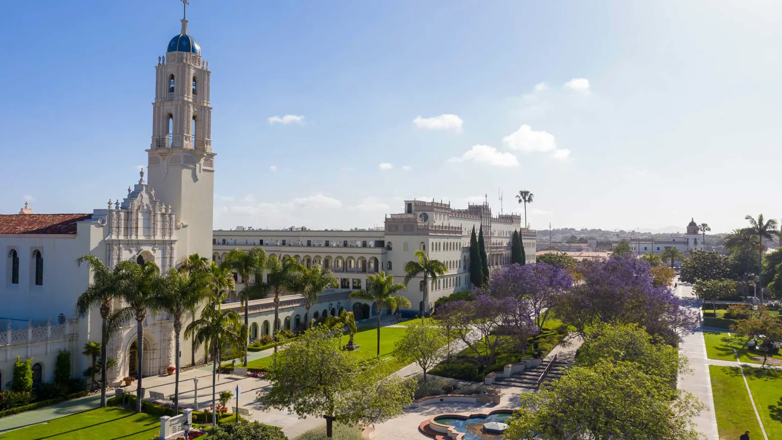 The Immaculata church tower and Spanish Renaissance style buildings above the fountain and gardens of the University of San Diego campus in San Diego, California