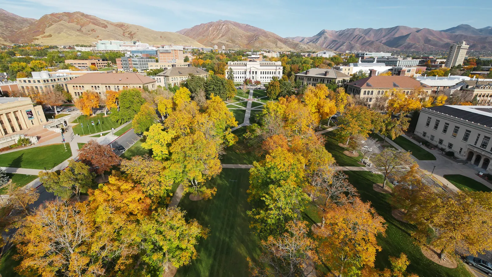 Autumn trees around Presidents Circle at the University of Utah, with the Wasatch foothills beyond