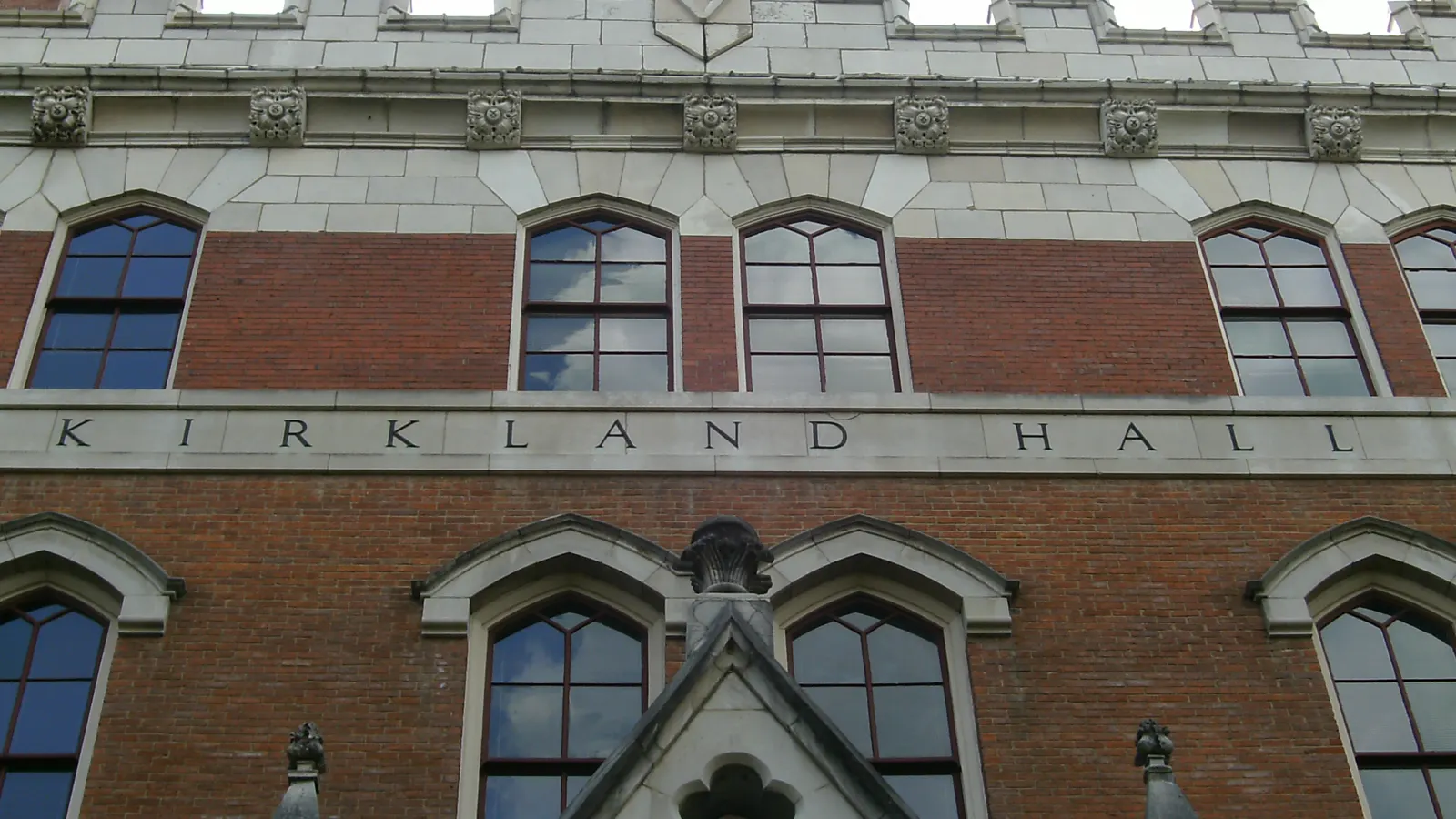 The red brick and stone front of Kirkland Hall, its name carved above the windows, at Vanderbilt University in Nashville, Tennessee