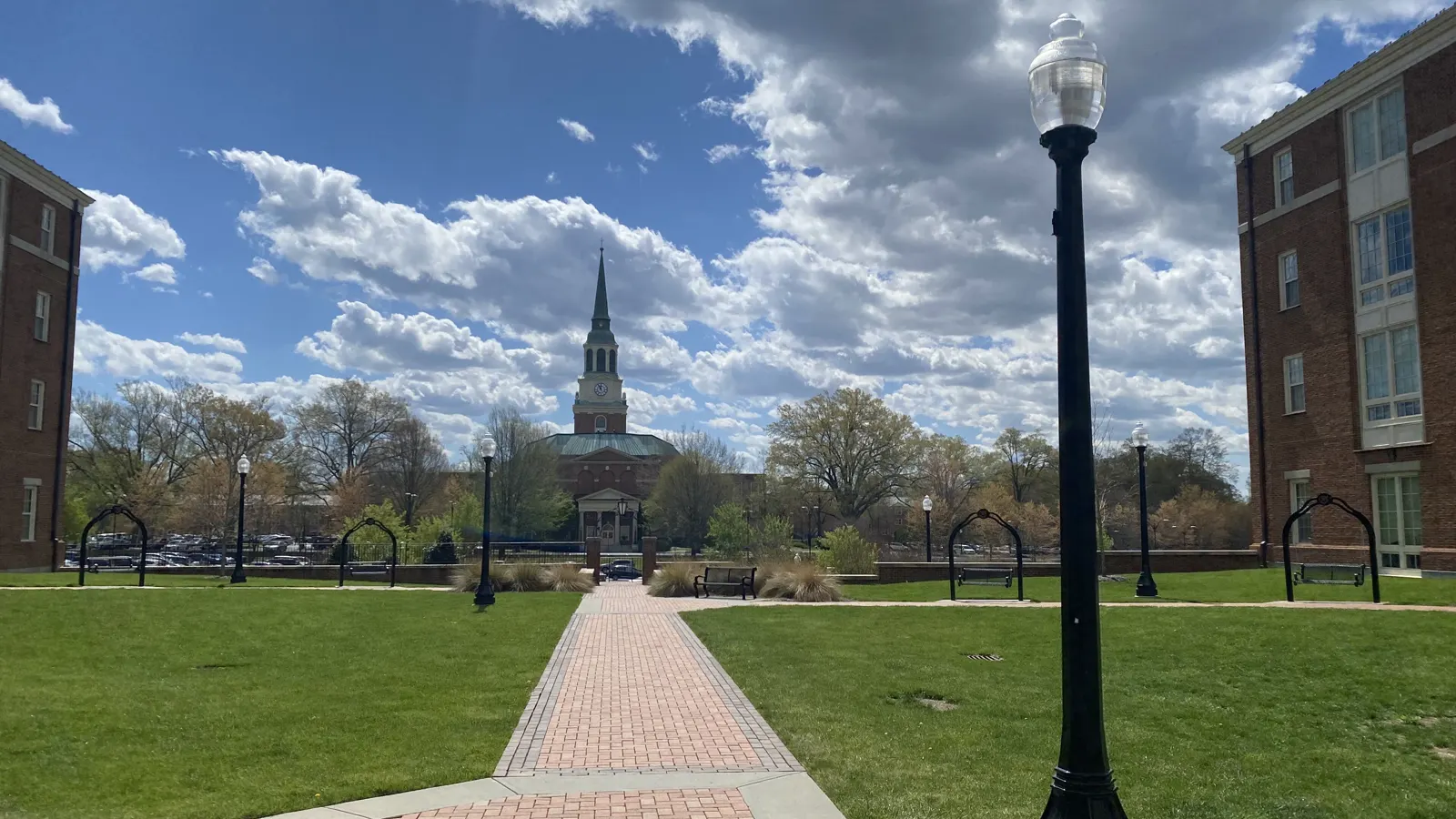 A brick walkway across a green quad toward the spire of Wait Chapel at Wake Forest University in Winston-Salem, North Carolina
